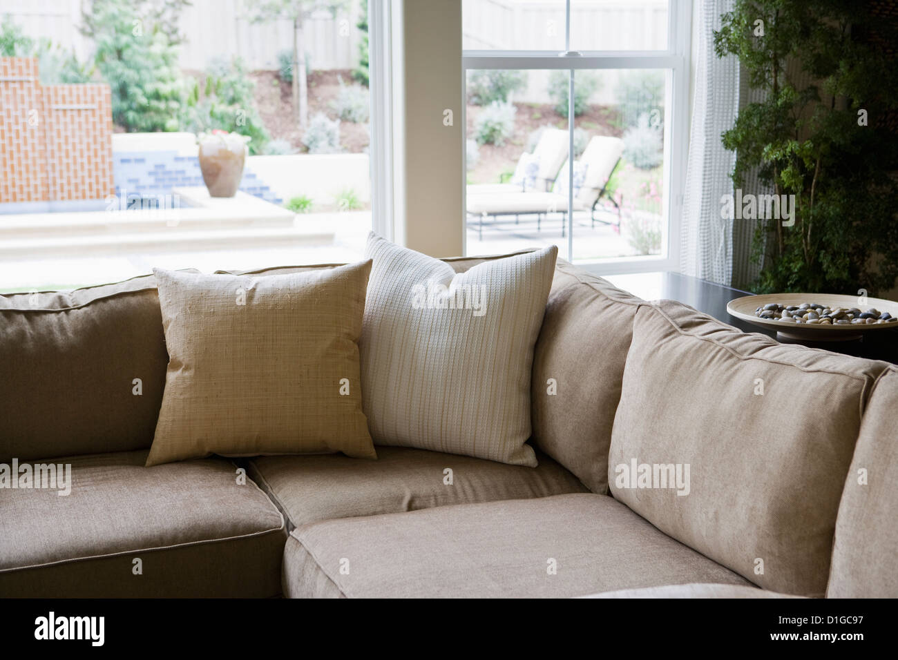 Sectional sofa in front of windows; San Diego; California; USA Stock Photo