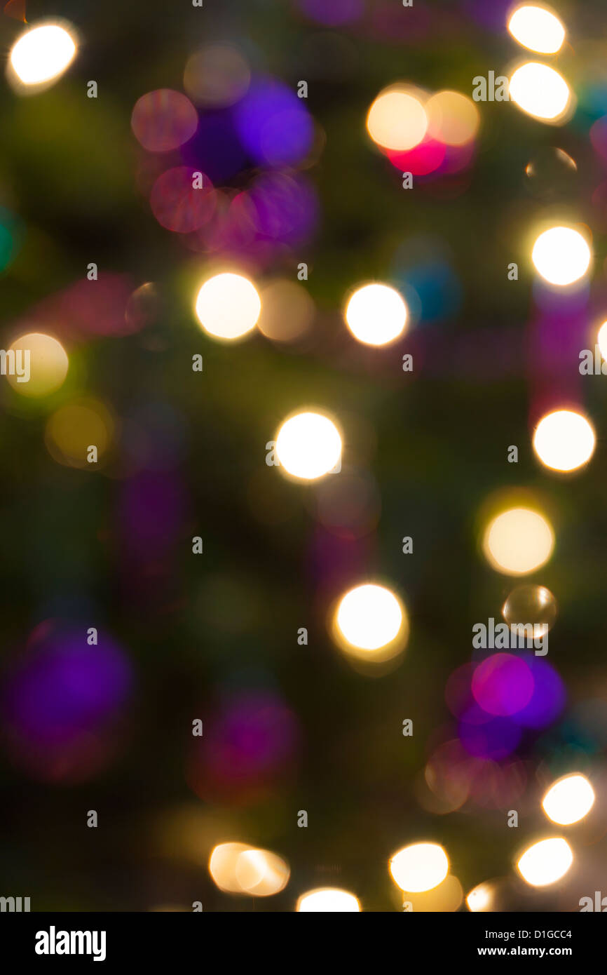 Blurred out of focus Christmas tree lights and baubles, abstract twinkling lights background. Stock Photo