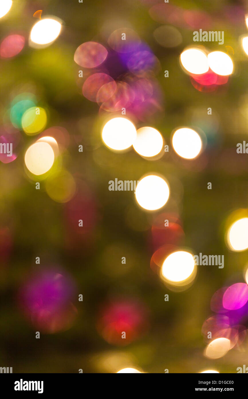 Blurred out of focus Christmas tree lights and baubles, abstract twinkling lights background. Stock Photo
