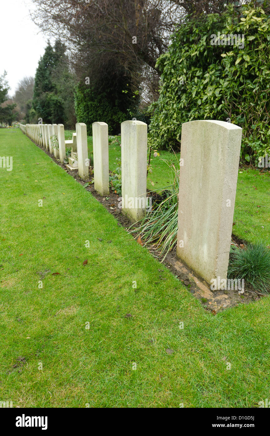 long rows of unnamed commemoration headstones of world war 1 British soldiers on bleak cold day Stock Photo