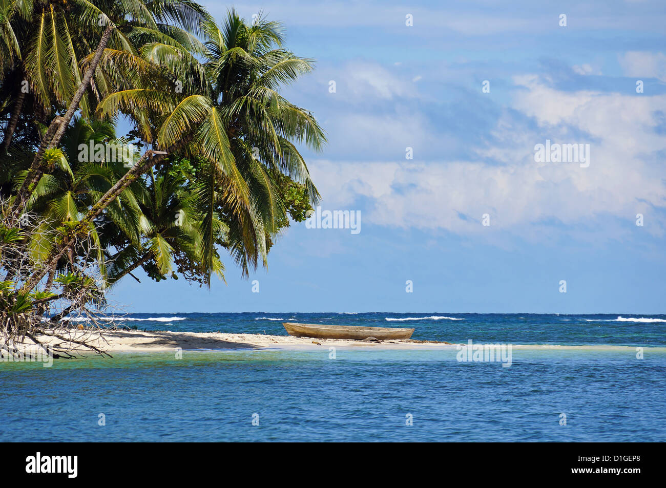 Tropical beach with beautiful coconut trees and a dugout canoe, Bocas del Toro, Caribbean sea, Panama Stock Photo