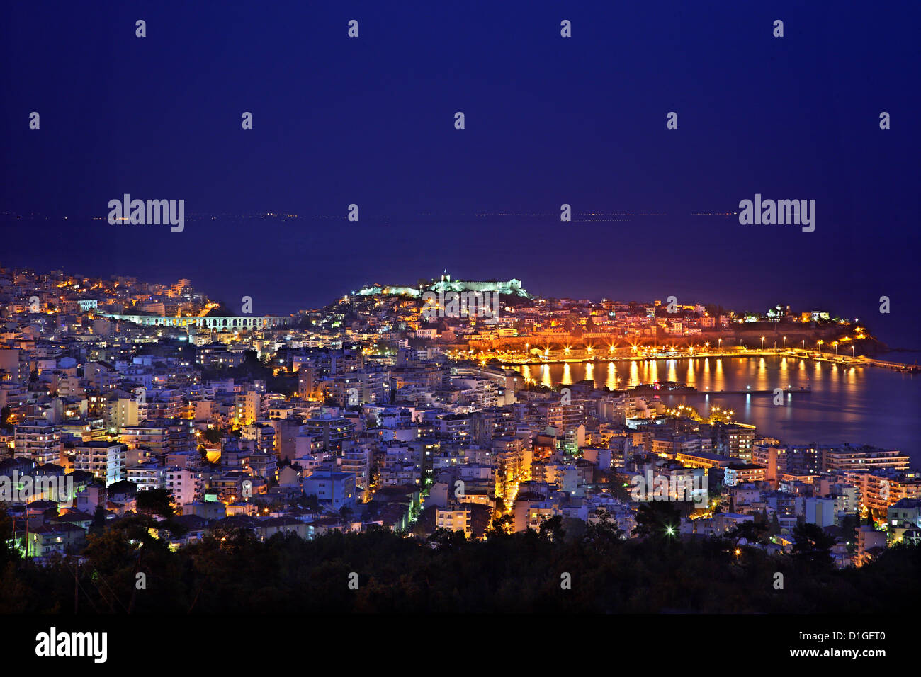 Panoramic night view of Kavala city, Macedonia, Greece. You can see the famous 'Kamares' (aqueduct), the port and the castle Stock Photo