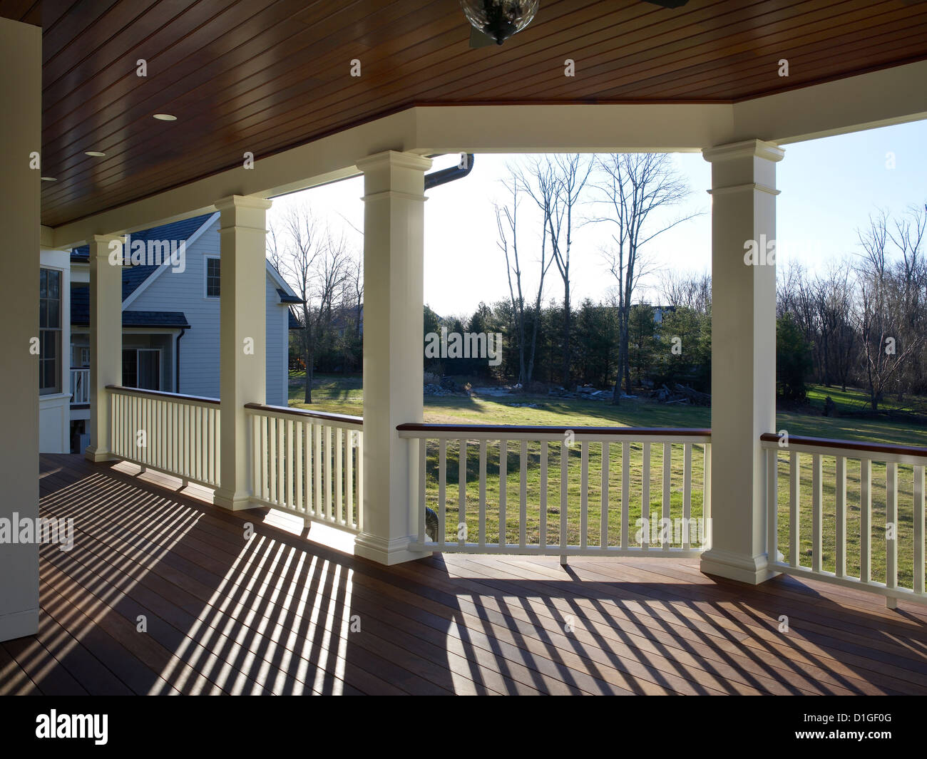 Porch With Sun Shining Making Shadows On Deck Stock Photo