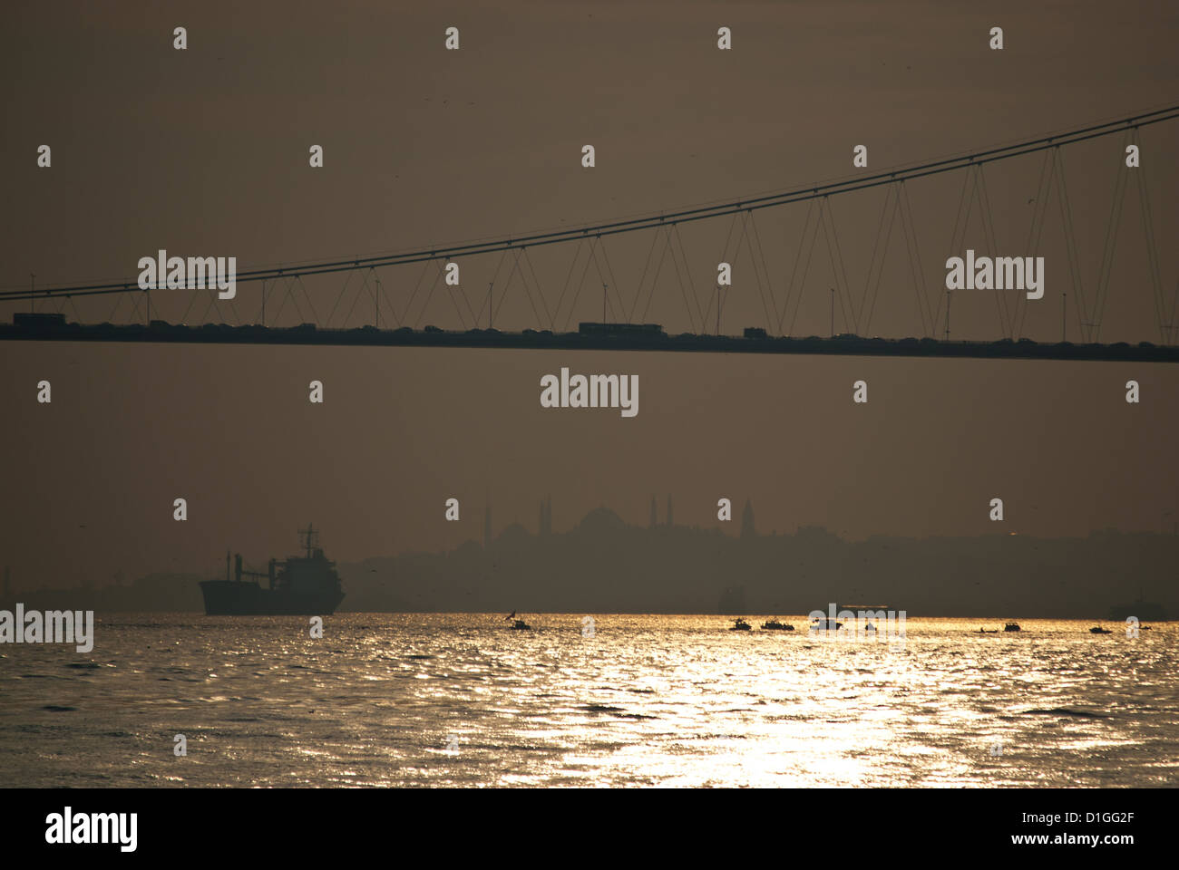 Bosphorus Suspensionbridge and cargo vessel, smog air, Istanbul, Turkey Stock Photo