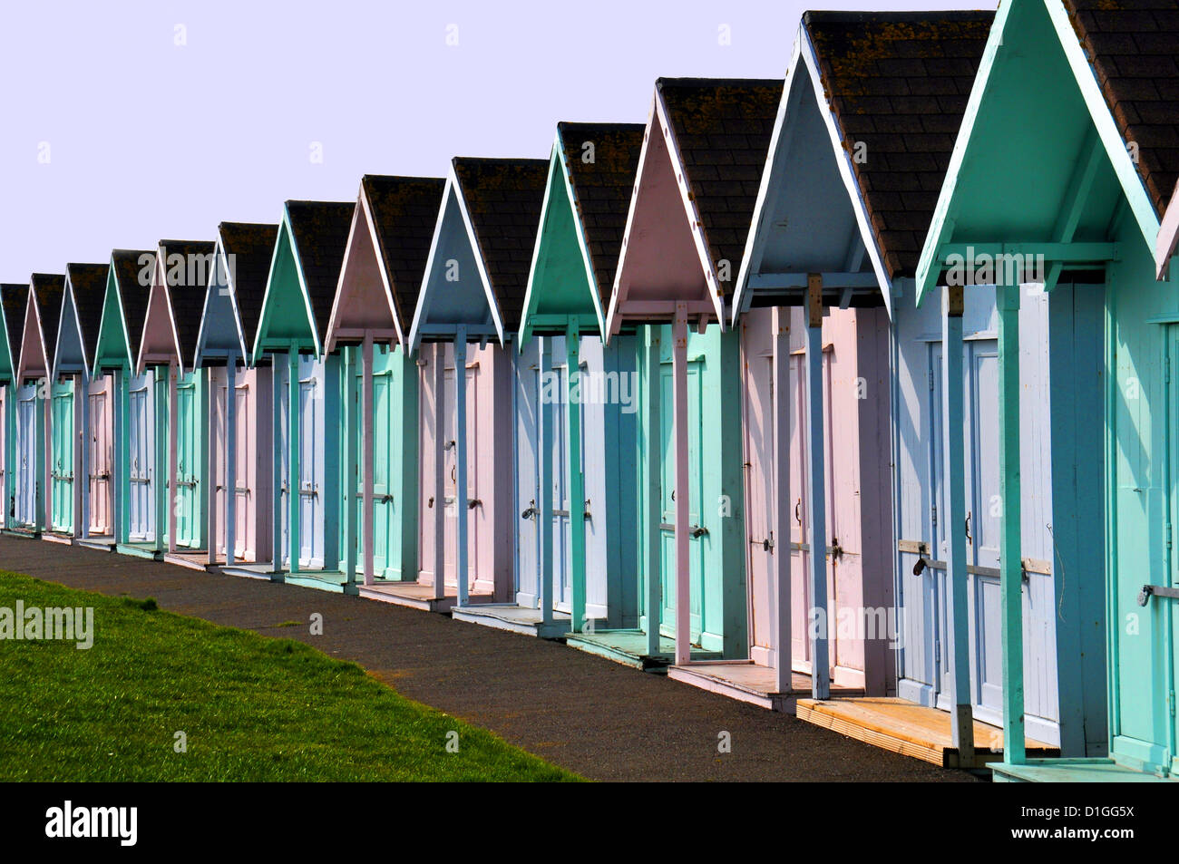 Multi coloured beach huts, used for changing on the beach in England Stock Photo