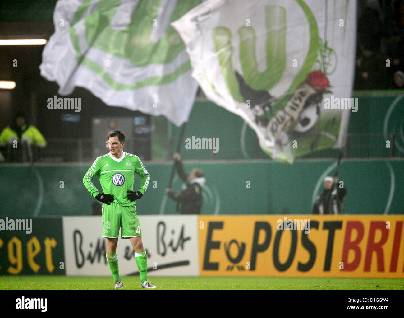 Wolfsburg's Marcel Schaefer stems his hands into his hips after his teammate Traesch scores the 1-1 goal during the DFB Cup soccer match between VfL Wolfsburg and Bayer Leverkusen at the Volkswagen-Arena in Wolfsburg, Germany, 19 December 2012. Photo: Peter Steffen Stock Photo