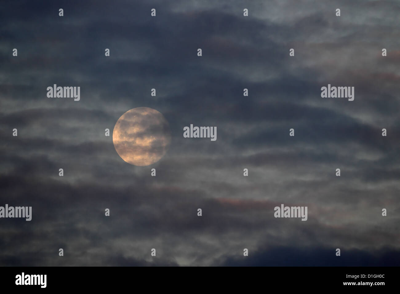 Moon partially obscured by cloud Stock Photo
