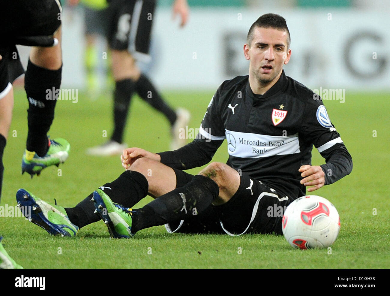 Stuttgart's Vedad Ibisevic sits on the pitch during the DFB Cup round of sixteen match between VfB Stuttgart and 1st FC Koeln at the Mercedes-Benz Arena in Stuttgart, Germany, 19 December 2012. Photo: Jan-Philipp Strobel Stock Photo