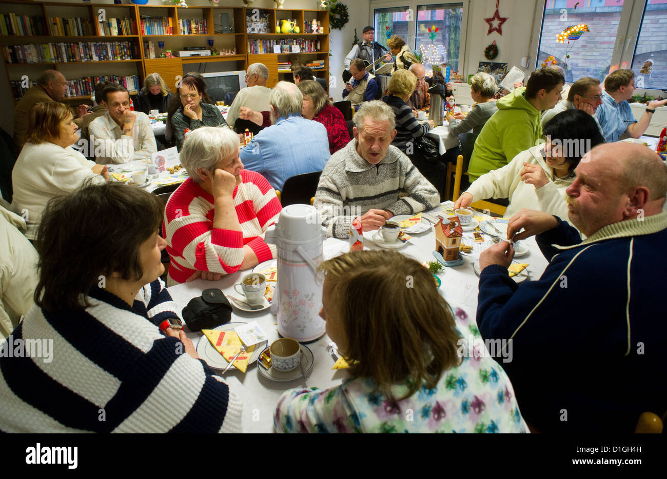 Needy people sit in the soup kitchen of the People's Solidarity in Potsdam, Germany, 20 December 2012. People's Solidarity invited around 80 homeless and needy people to a Christmas party. Photo: Patrick Pleul Stock Photo