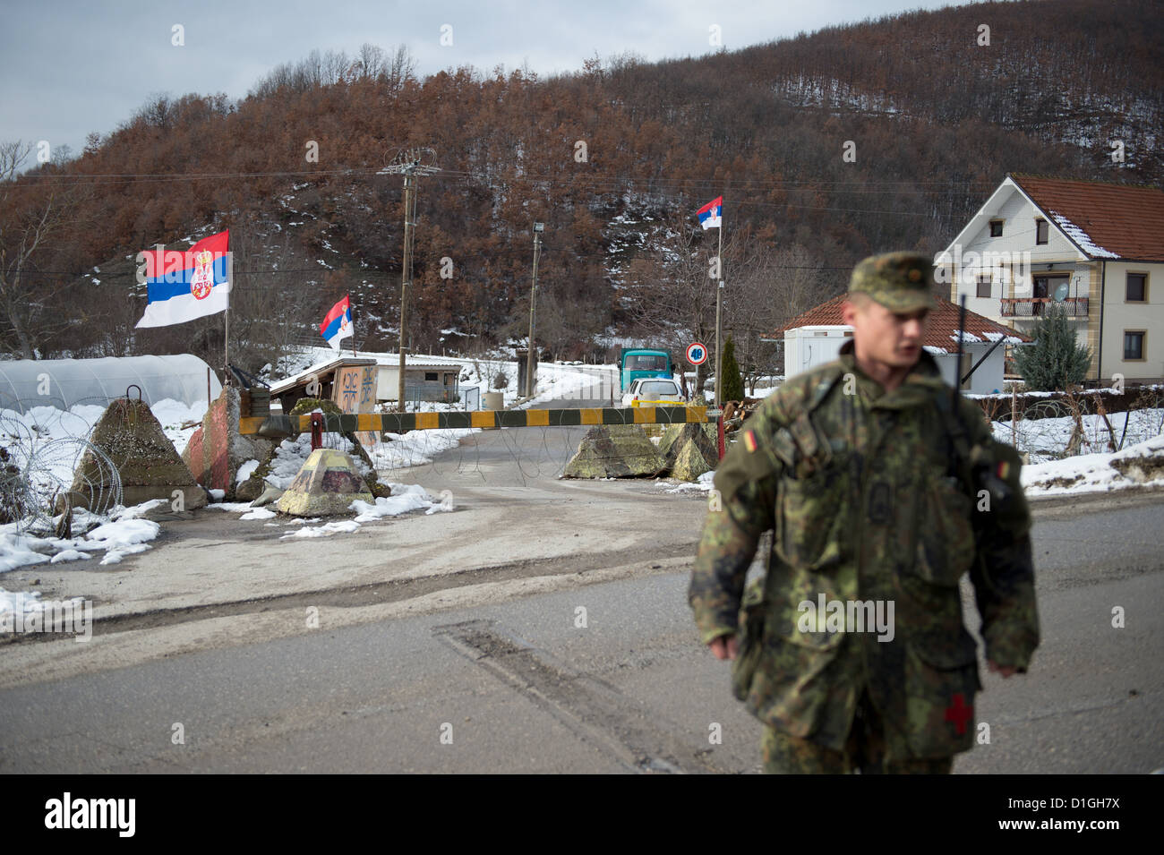 Deutsche Soldaten der Kosovo-Schutztruppe KFOR bewachen am 20.12.2012 in Zupce im Kosovo eine Straßensperre vor dem Haus des Bürgermeisters. Verteidigungsminister Thomas de Maiziere besucht für einen Tag die deutschen KFOR-Soldaten im Kosovo. Foto: Axel Schmidt/dpa (zu dpa 0488 vom 20.12.2012) Stock Photo