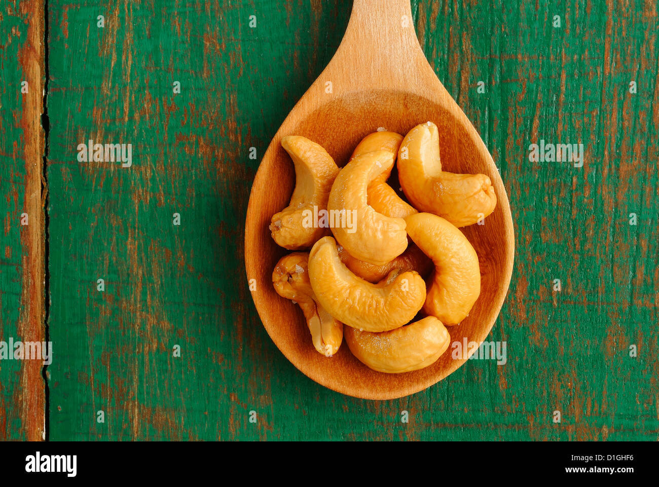 Salted cashews in wooden spoon Stock Photo
