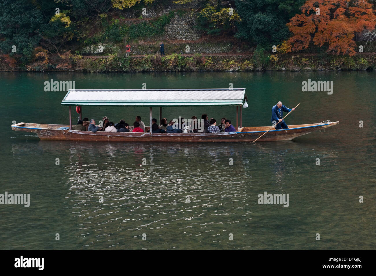 Tourists taking a boat trip along the Katsura River in Arashiyama, Kyoto, Japan Stock Photo