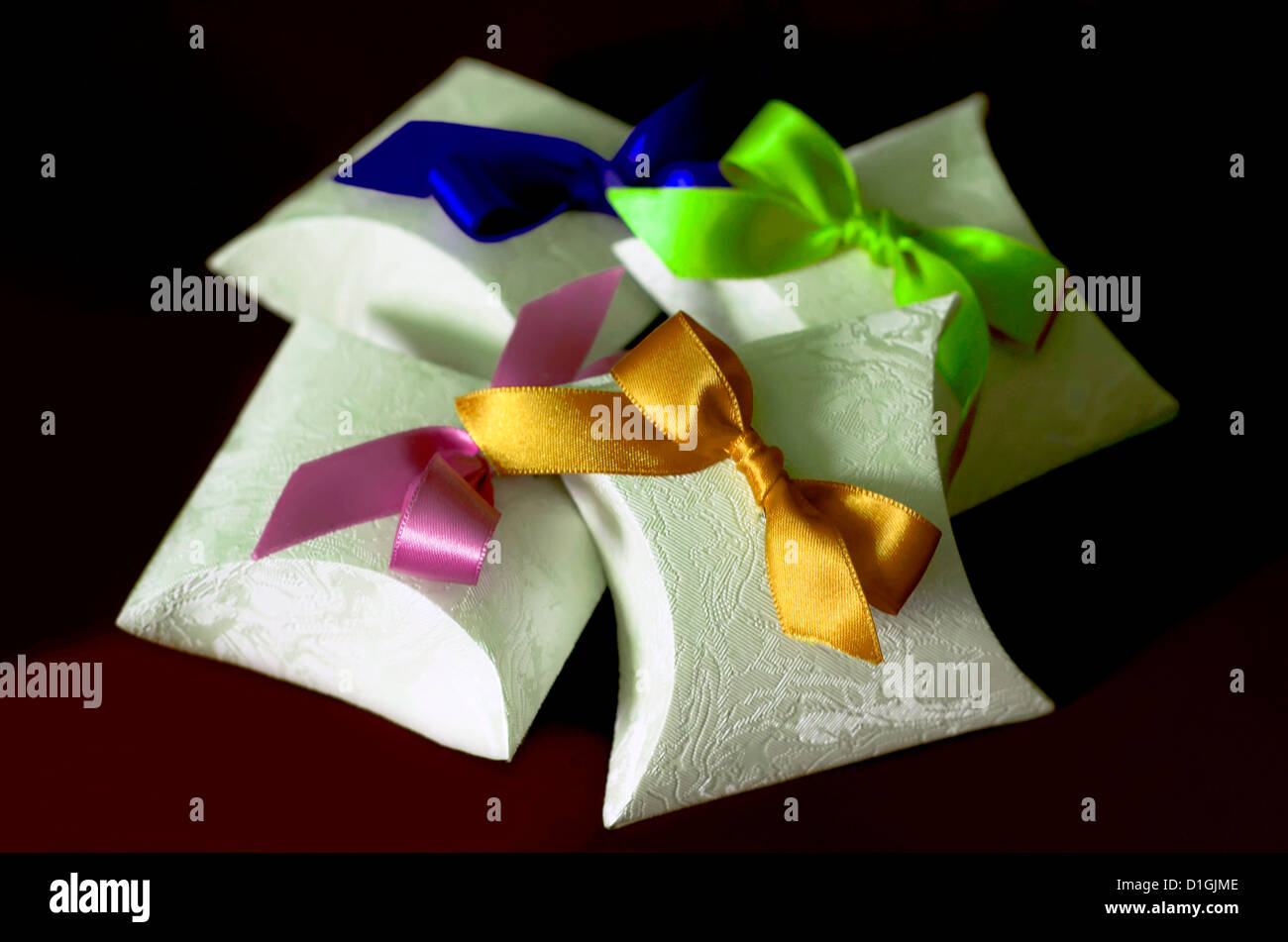 Paper boxes with colorful bows on brown Stock Photo