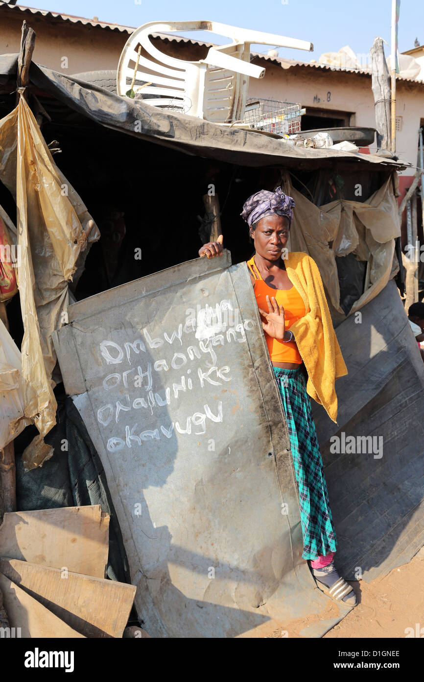A women stands in the doorway of her shack in a camp of a poor neigbourhood in Tsumeb, Namibia Stock Photo
