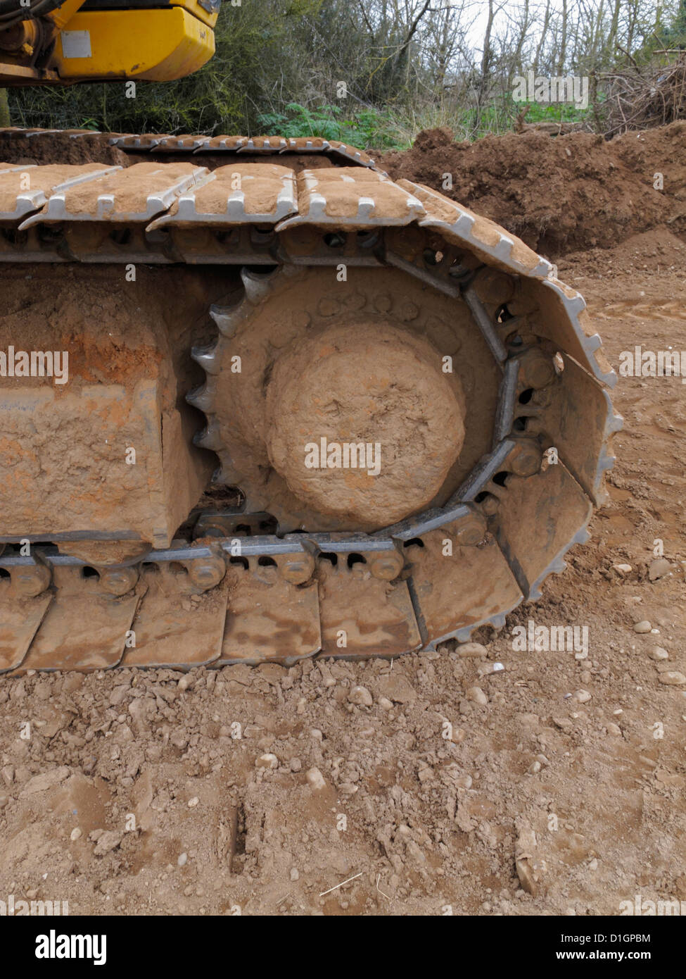 Closeup detail of the caterpillar track of a large tracked excavator on a highway construction site UK Stock Photo