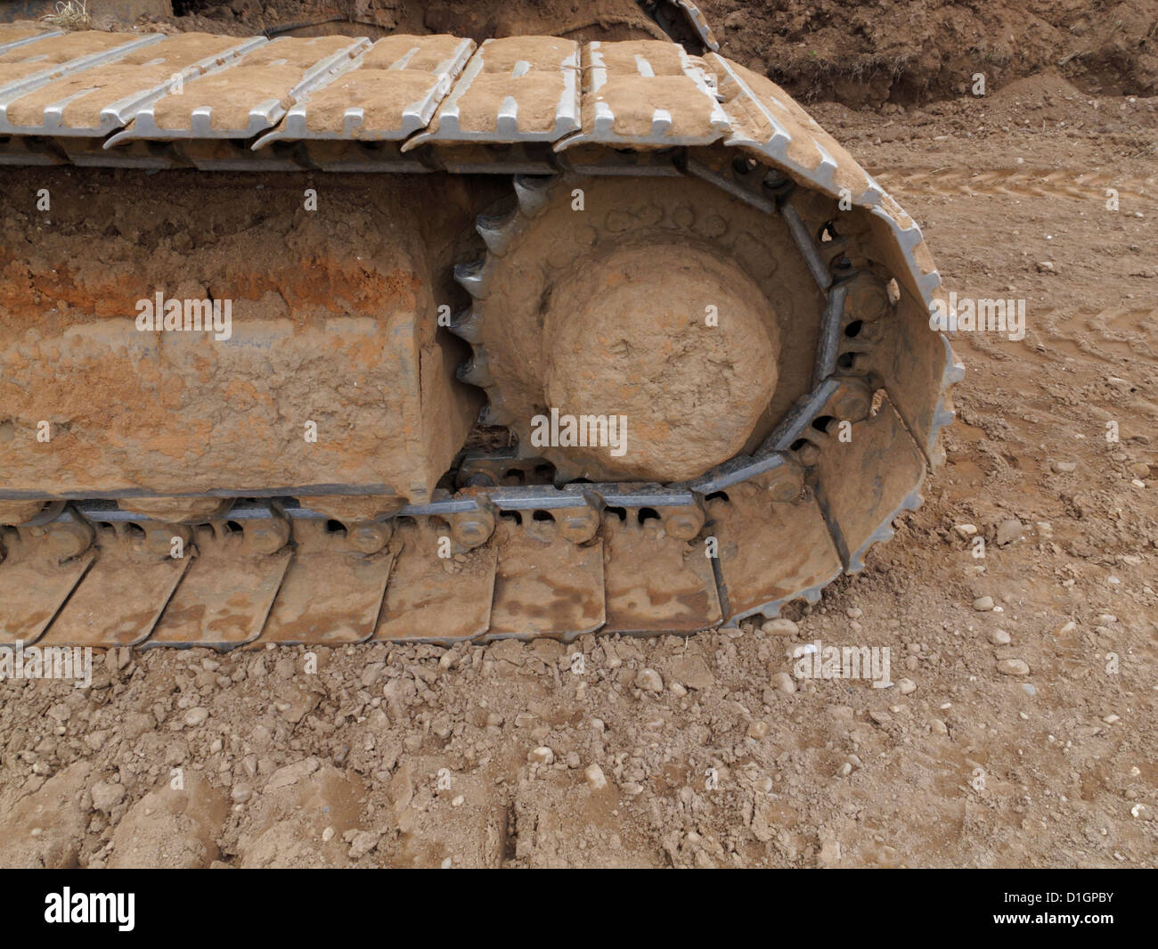 Closeup detail of the caterpillar track of a large tracked excavator on a highway construction site UK Stock Photo