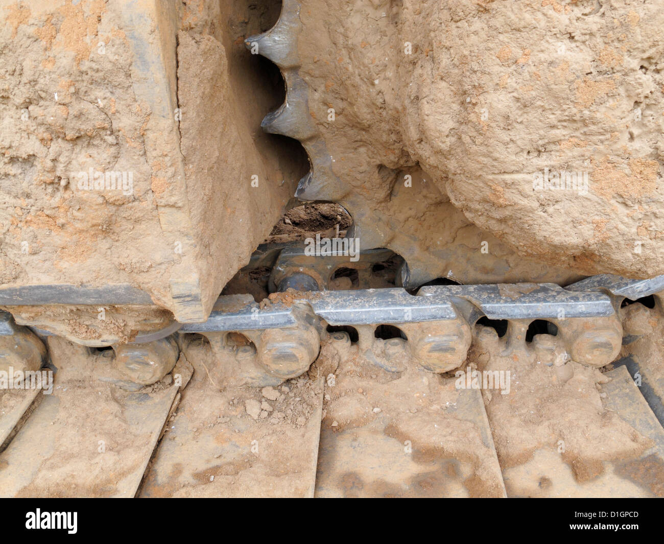 Closeup detail of the caterpillar track of a large tracked excavator on a highway construction site UK Stock Photo