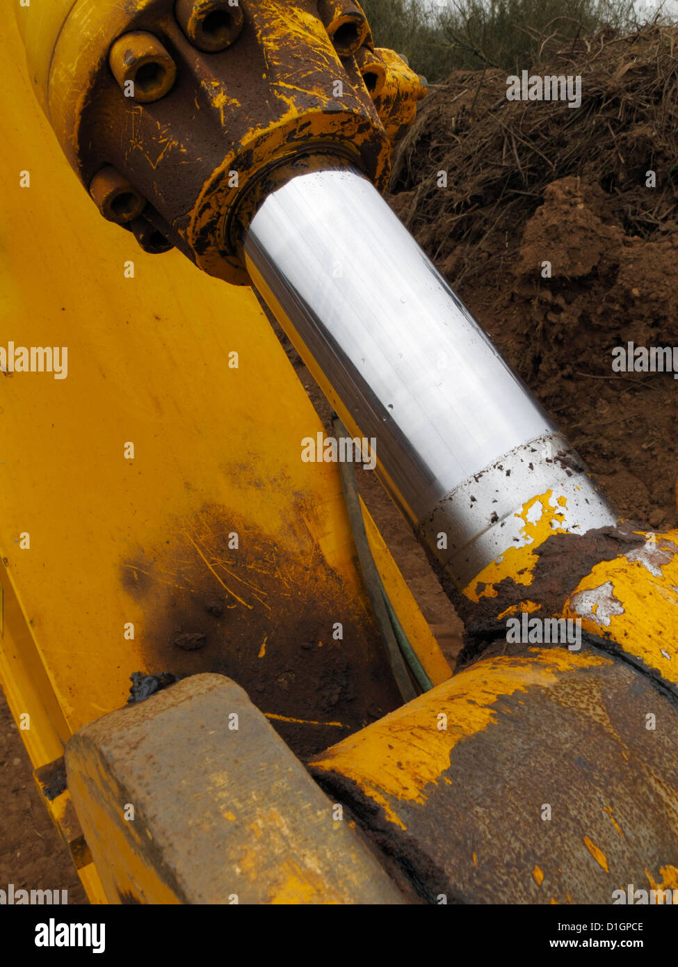 Close up of large chrome plated hydraulic ram shaft  of digger bucket earthmoving new road building construction site uk Stock Photo