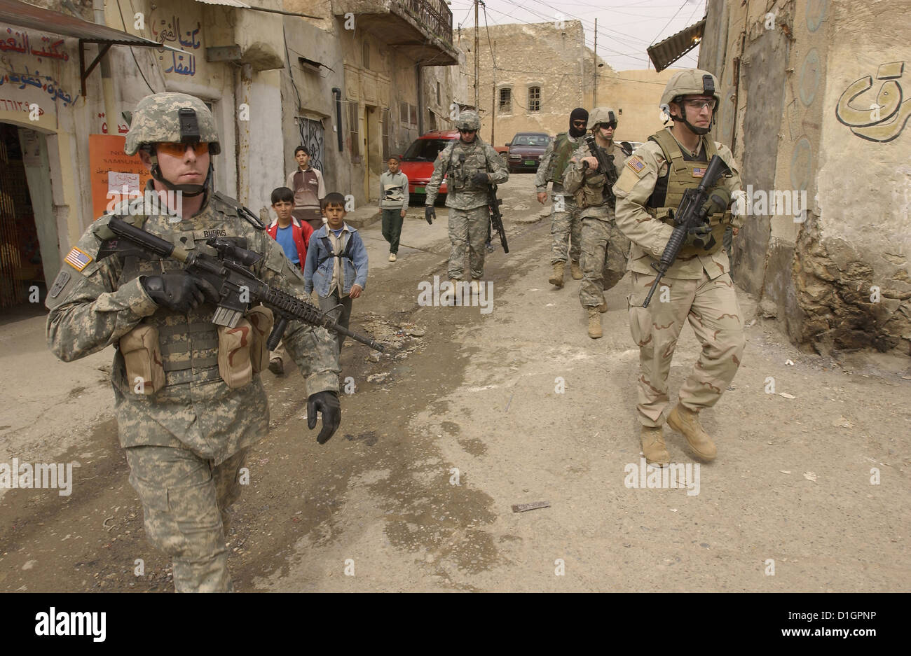 US Army Soldiers patrol the streets of Tall Kayf, Iraq on March 1, 2006. Stock Photo