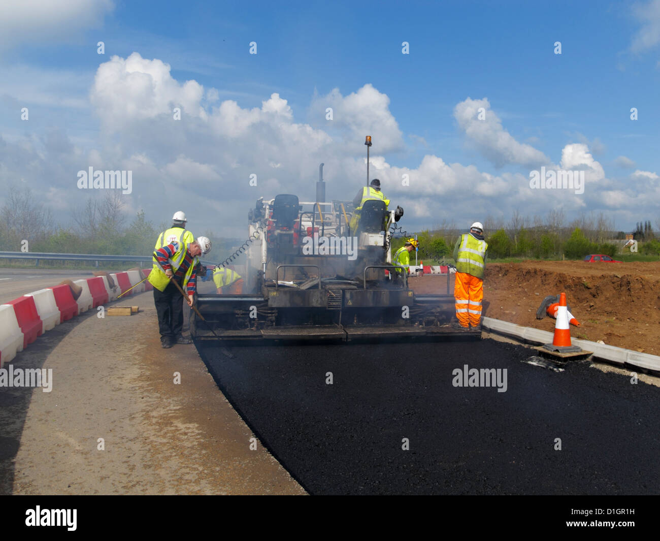 A Civil Engineering contractor highway maintenance gang  laying asphalt road surfacing in UK Stock Photo