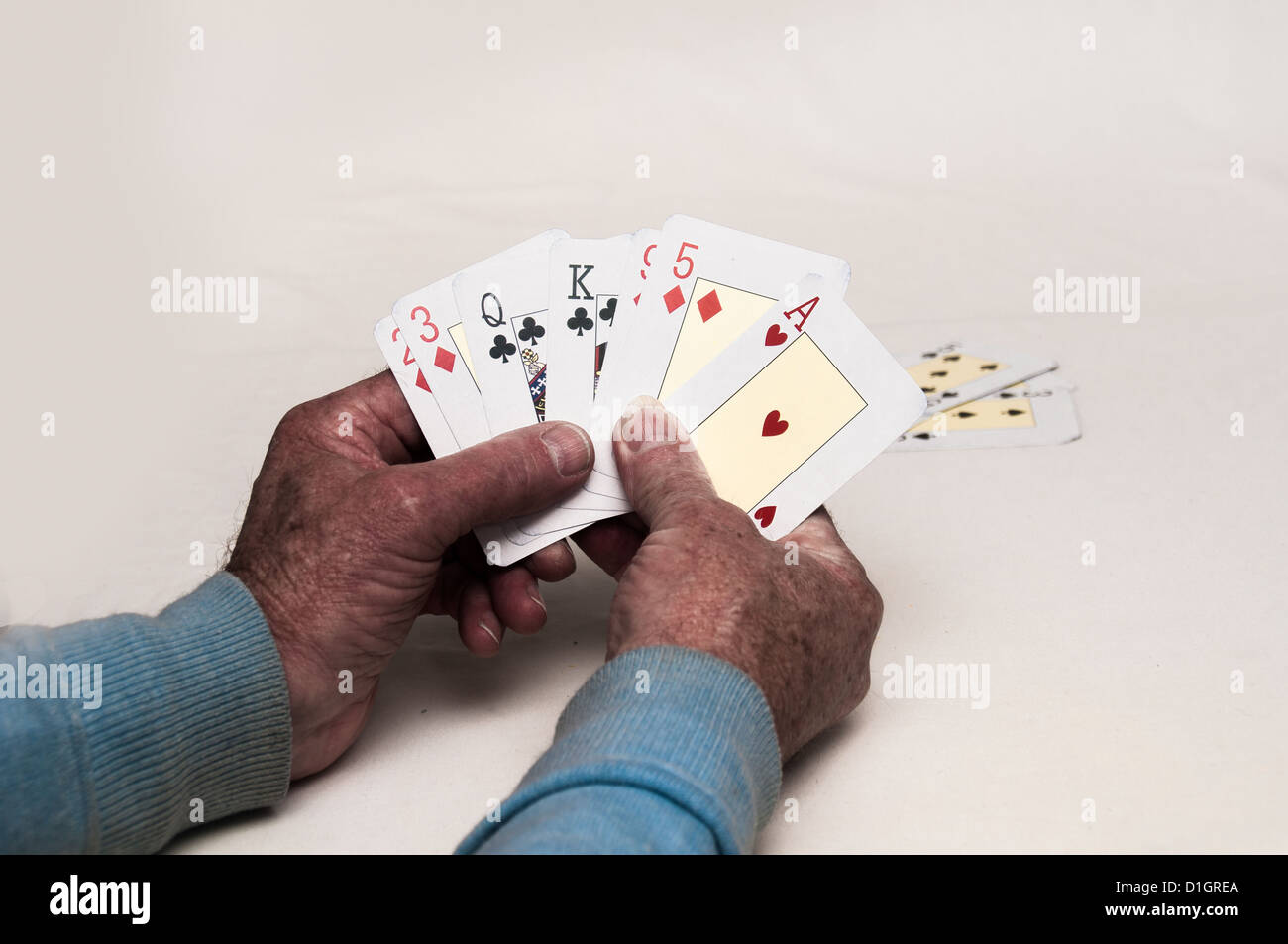 A card player shows his hand Stock Photo