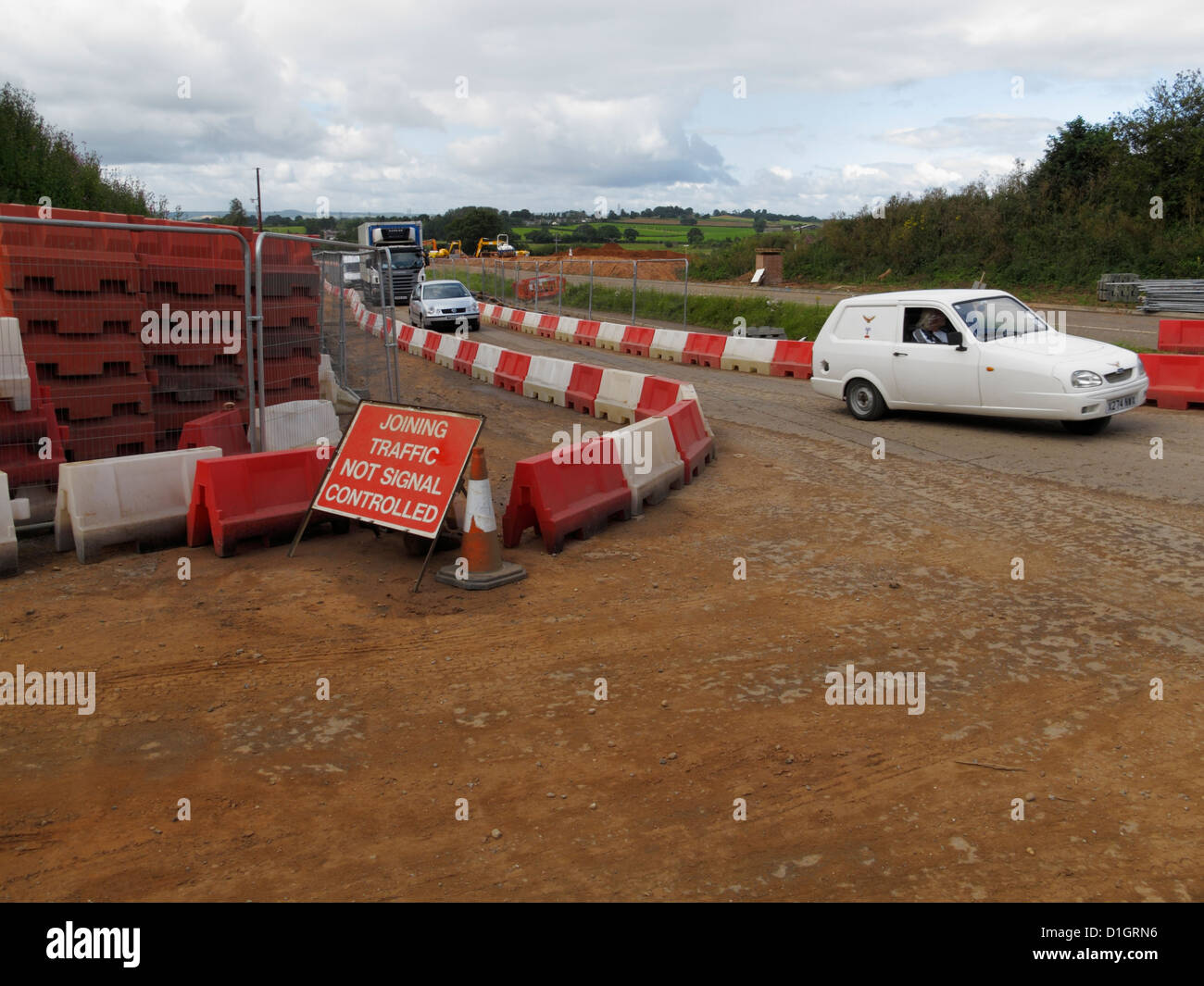 Water filled barriers marking temporary diversion through roadworks uk Reliant robin rialto threewheeler a forest of cones van Stock Photo