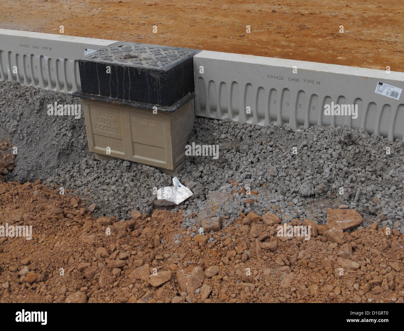 Road construction site closeup detail ACO drainage kerbs and gullies system  of hollow kerbing acting as a carrier drain UK Stock Photo - Alamy