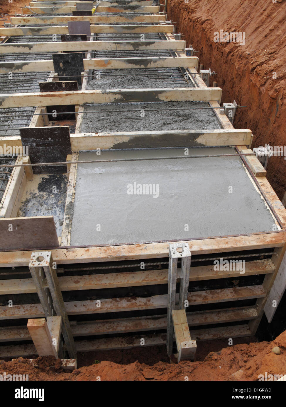 Pouring concrete for a reinforced concrete bridge foundation strip