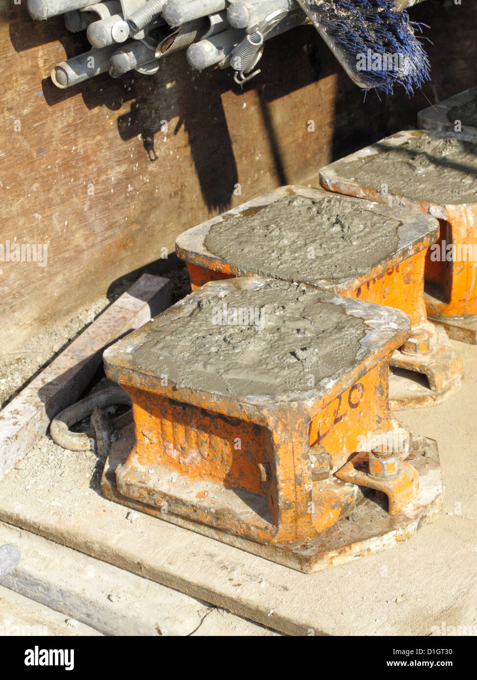 Samples of concrete in cube molds prepared for compressive strength test on road construction site Stock Photo