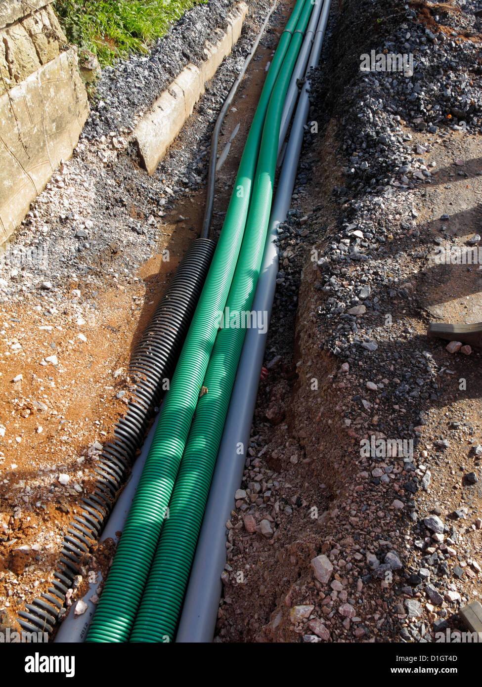Crowded and other ducts being laid under a footway UK duct