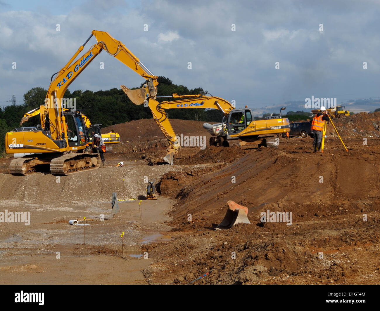 Tacked excavators working on new road construction site UK Stock Photo