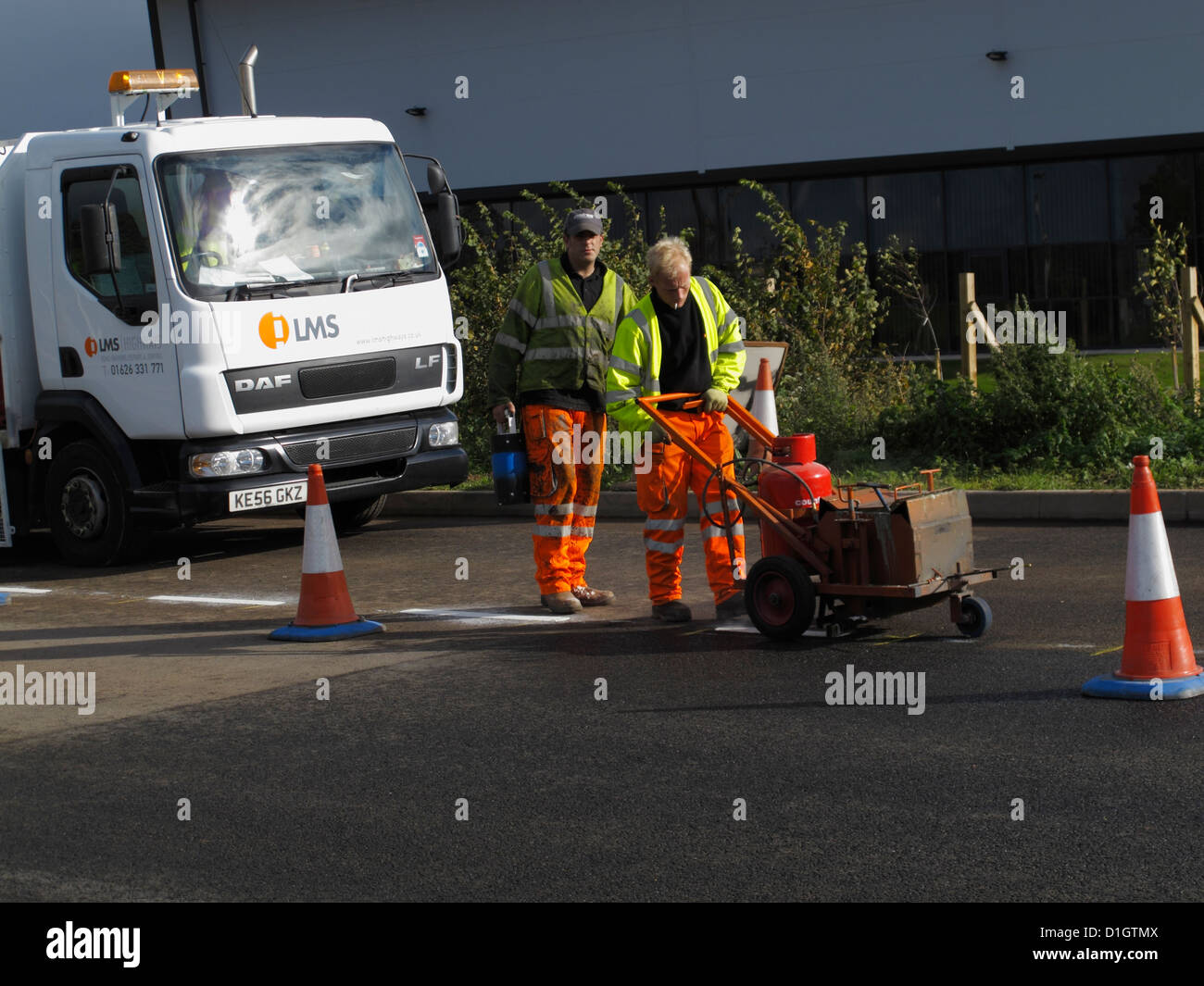 Road marking lining gang screeding white lines on a highway UK using