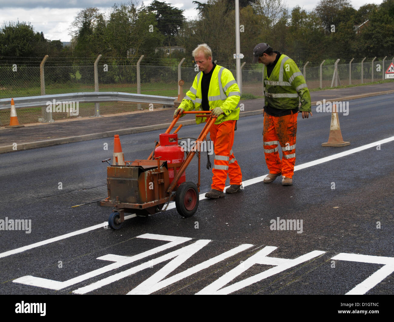 Road marking lining gang screeding white lines on a highway UK using