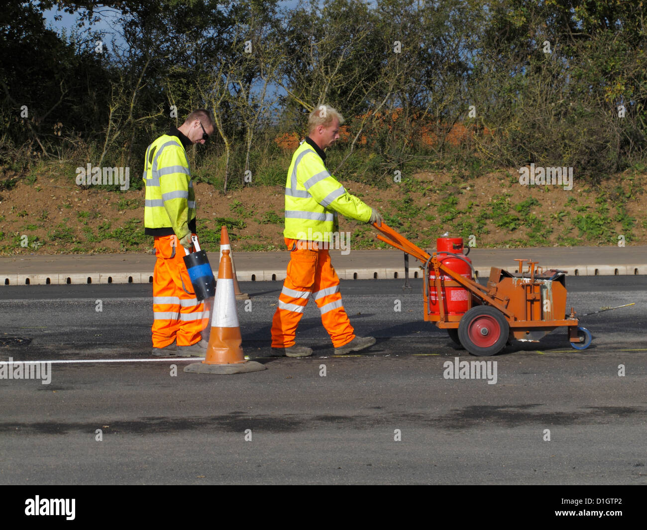 Road marking lining gang screeding white lines on a highway UK using
