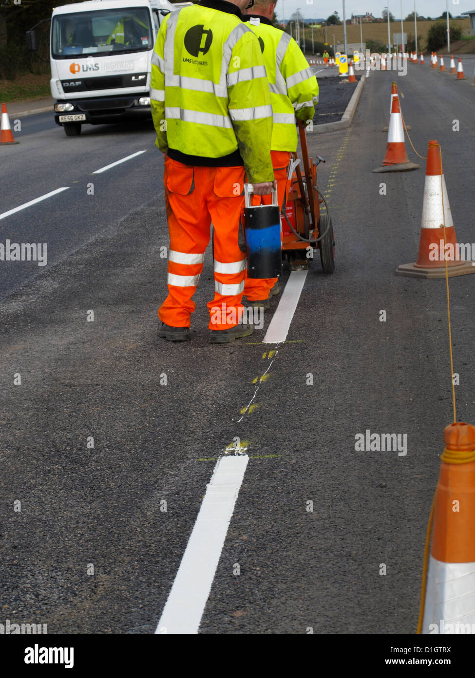 Road marking lining gang screeding white lines on a highway UK using
