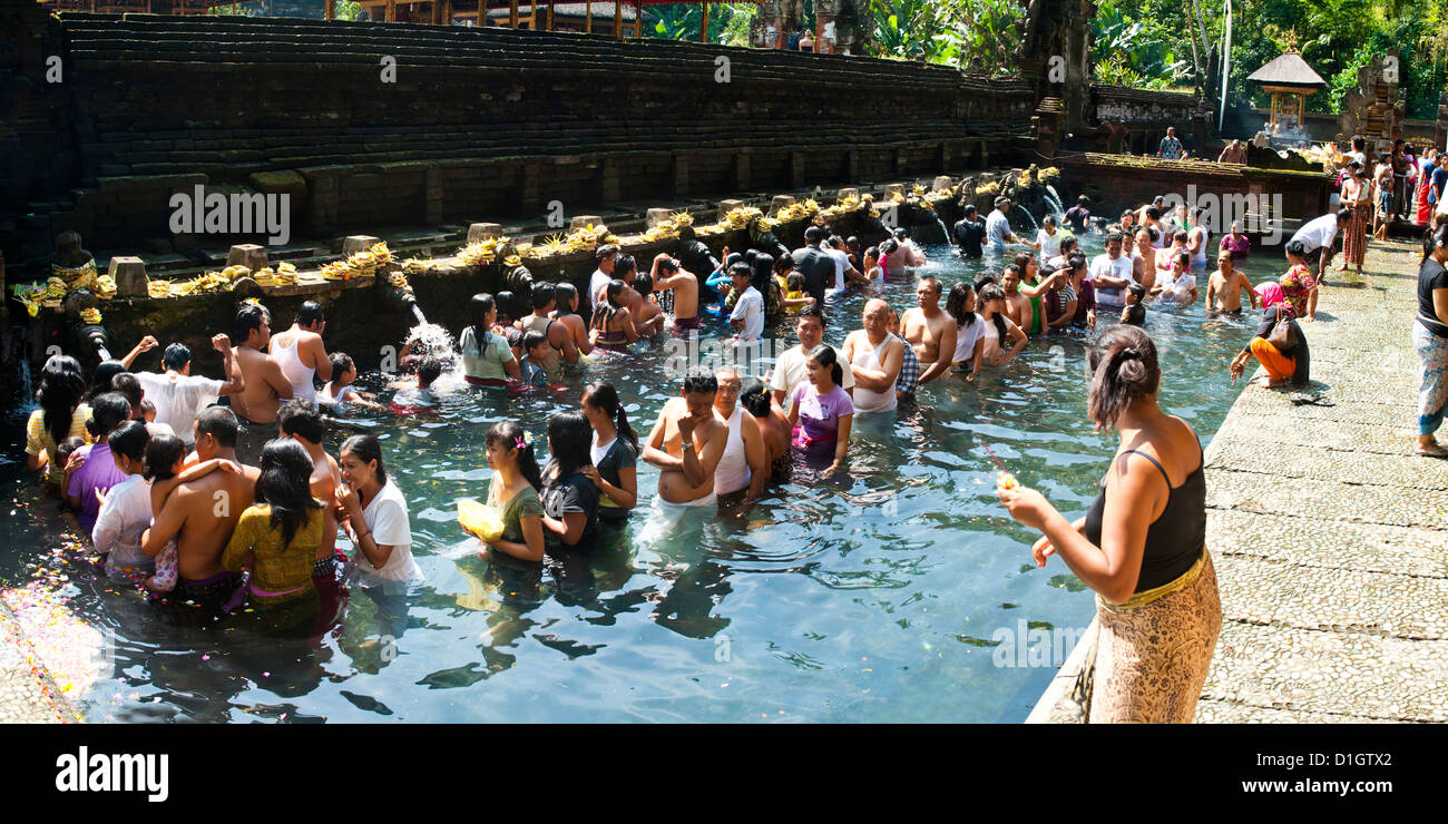 Panorama of Balinese people in Holy Spring Water in the Sacred Pool at Pura Tirta Empul Temple, Bali, Indonesia, Southeast Asia Stock Photo