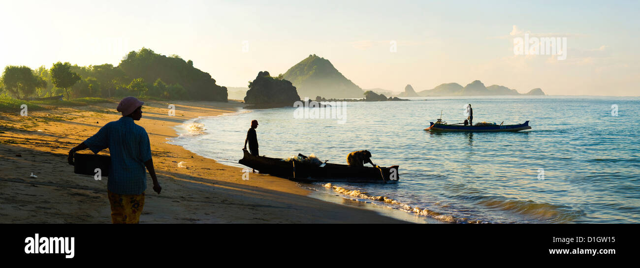 Panorama of a woman waiting for the fisherman to return at Kuta Beach, Kuta Lombok, Indonesia, Southeast Asia, Asia Stock Photo