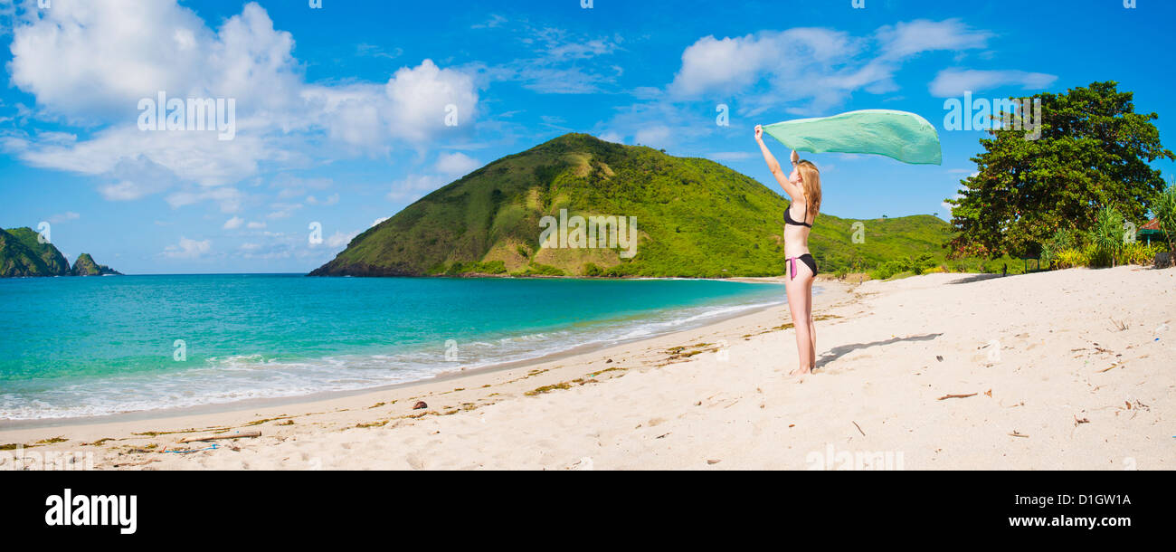 Woman celebrating freedom at Mawun Beach, a Tropical Paradise in South Lombok, Indonesia, Southeast Asia, Asia Stock Photo