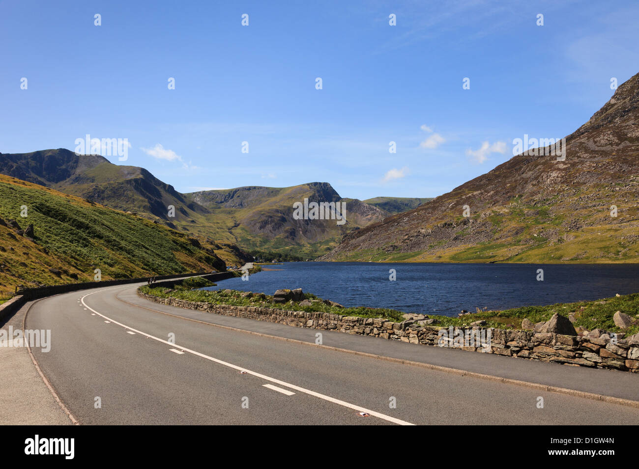 A5 historic coaching road route to Holyhead built by Thomas Telford by Llyn Ogwen Lake passing through mountains of Snowdonia North Wales UK Stock Photo