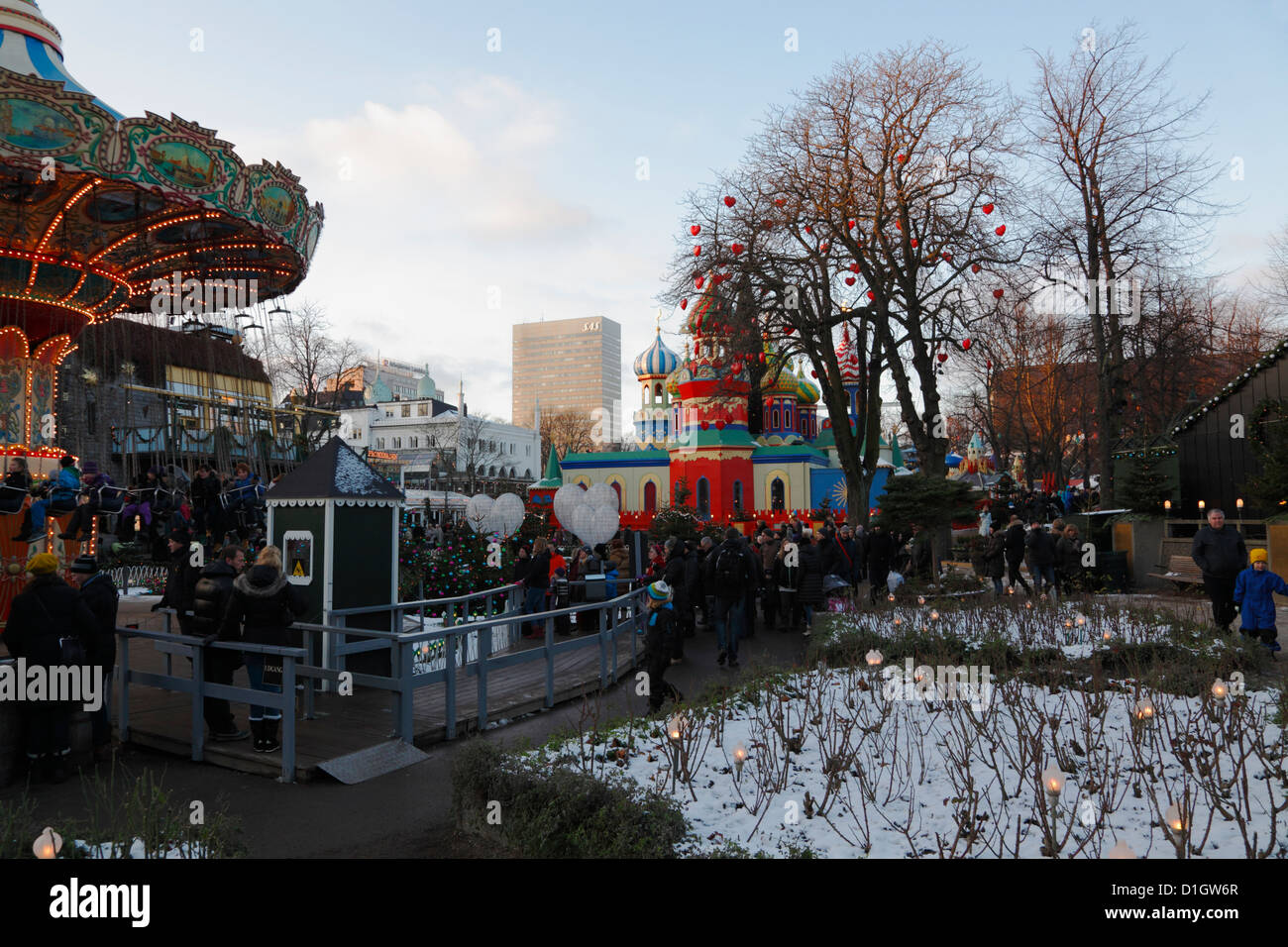Christmas market in Tivoli, Copenhagen. Merry-go-round and the Tivoli version of St. Basil's Cathedral,The Red Square, Moscow Stock Photo