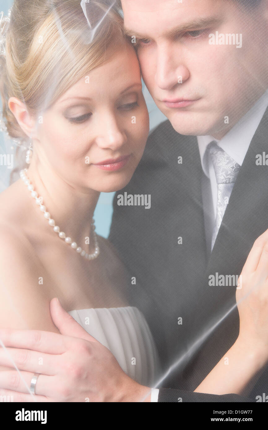 Bride and groom under a veil, happy moment Stock Photo