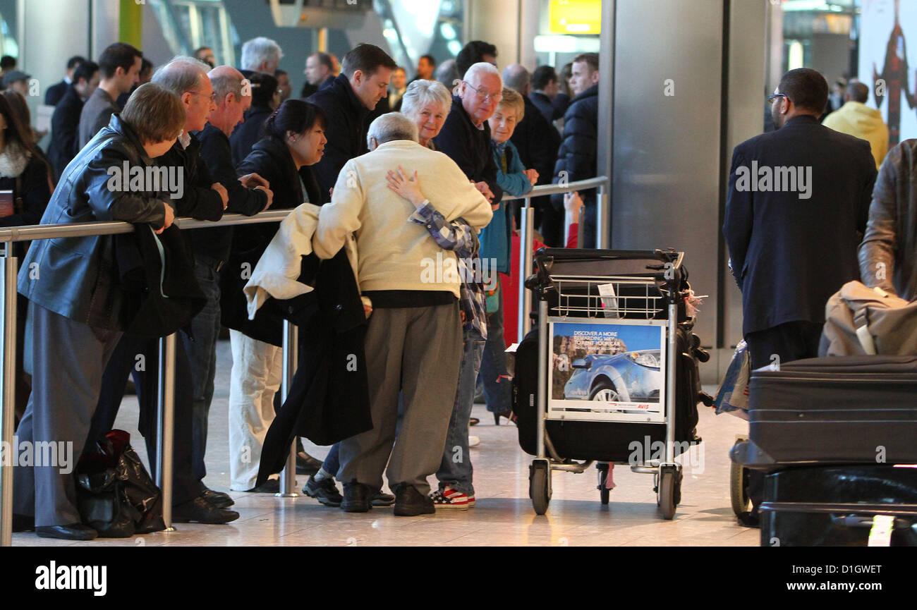 London Heathrow Airport Terminal 5 Arrivals 21 December 2012. Relatives meet loved ones from a flight into London. Today is expected to be the busiest of the year for UK Airports. Stock Photo