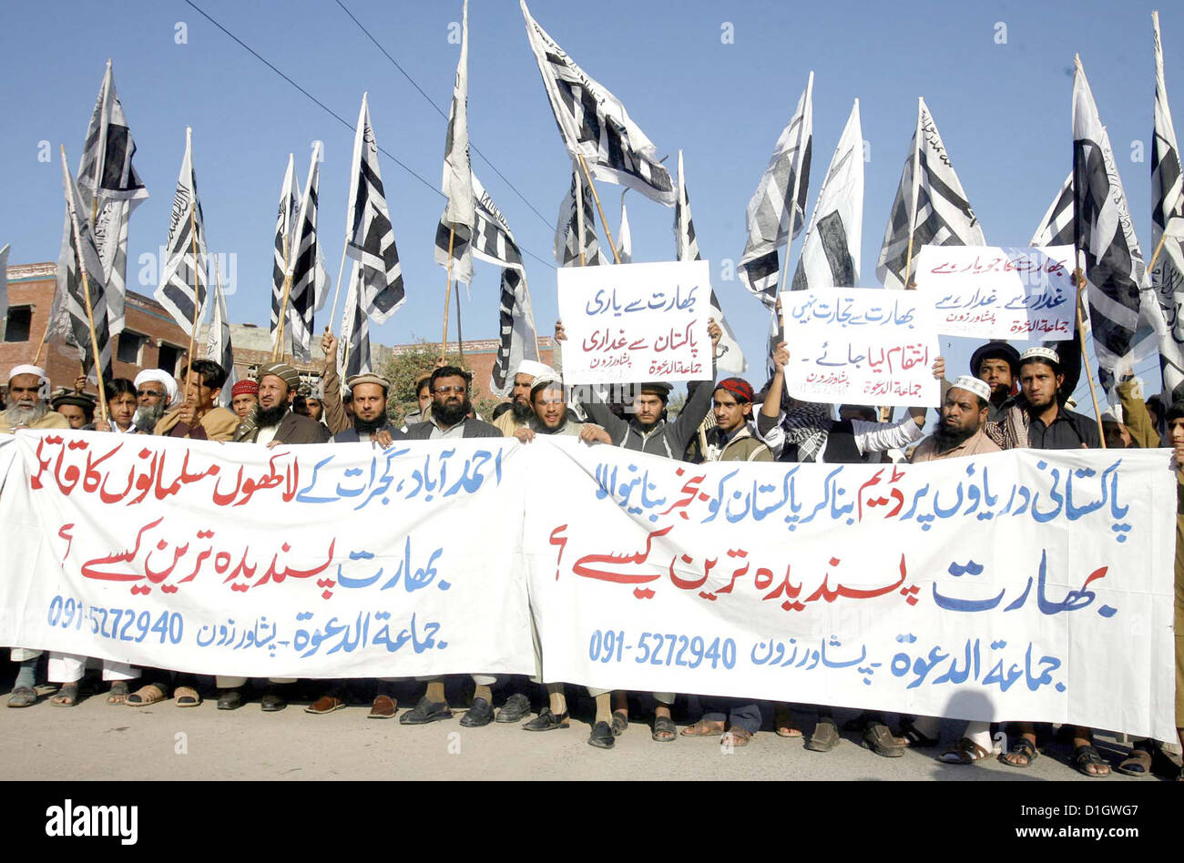 Activists of Jamat-ud-Dawah chant slogans India during a  protest demonstration at Peshawar press club on Friday, December 21, 2012. As they mark  Friday as protest day they condemn the appellation of “Most Favorite Country” for India gave by  Pakistan and demanding from UNO to reopen the case regarding killing of Muslims in Gujrat  riots. Stock Photo