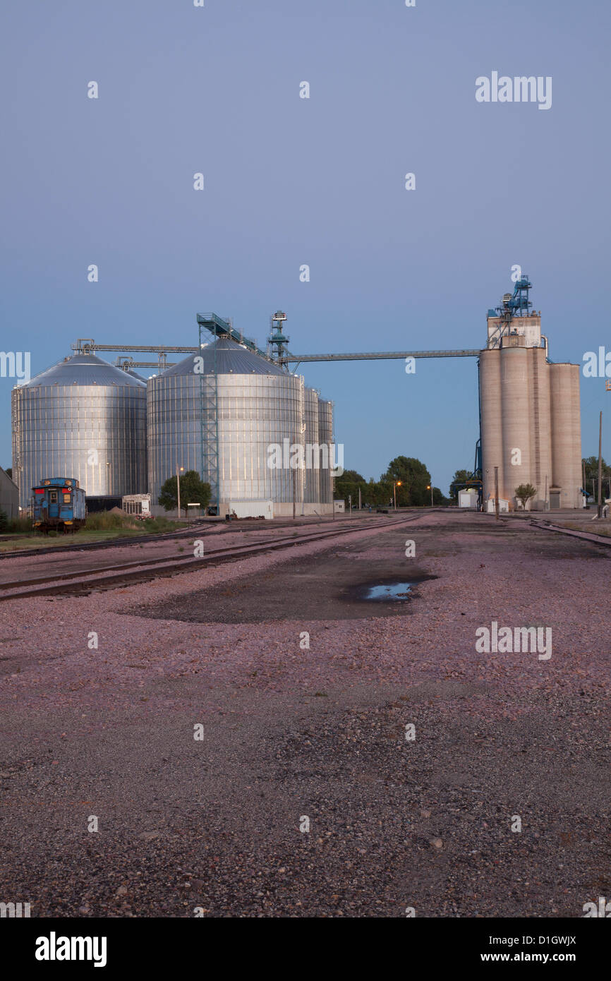 Rail tracks, grain silos and elevator at Redfield, South Dakota, at dusk. Stock Photo