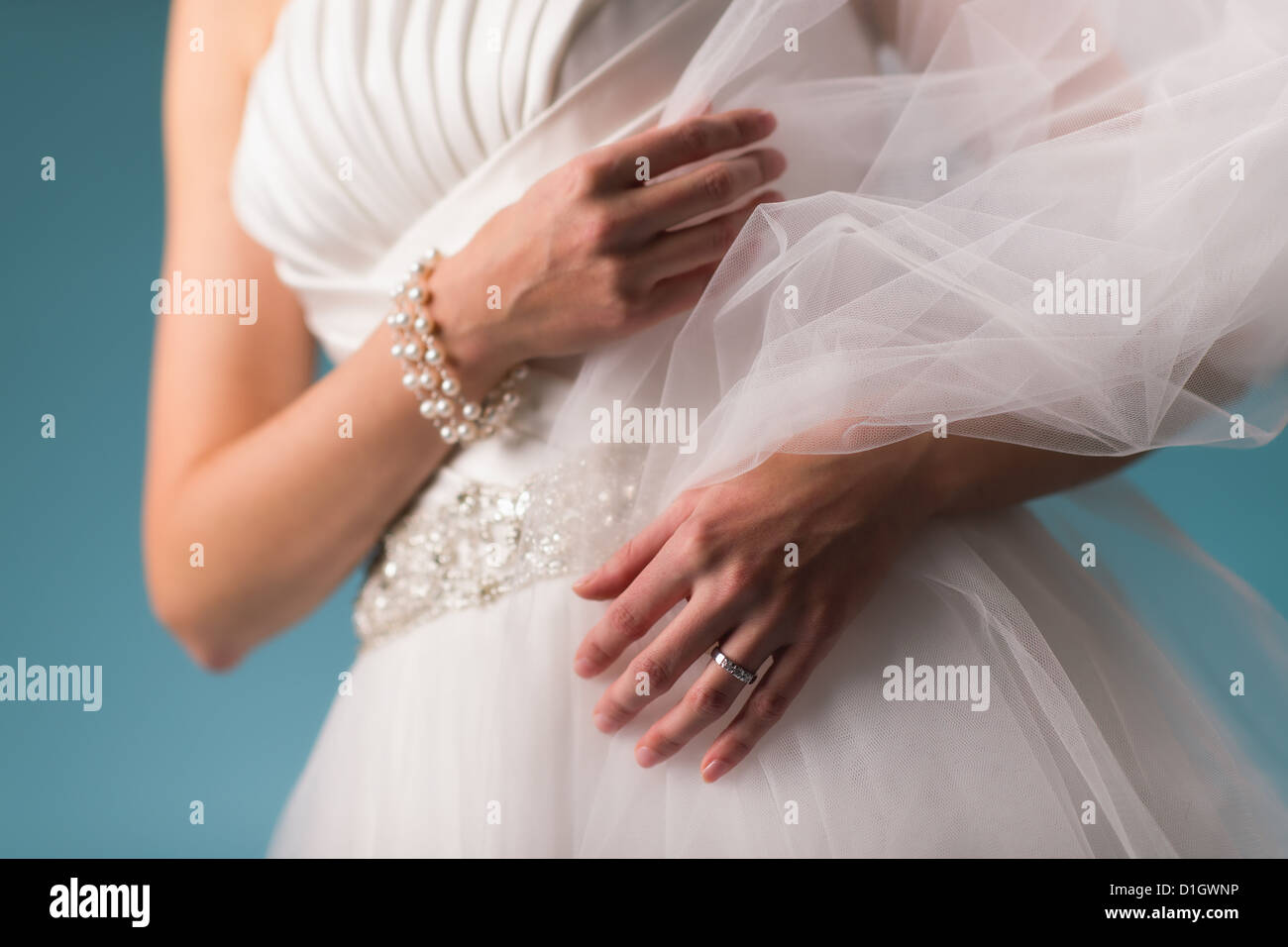 Close up wedding dress, very narrow depth of field and focus on the ring, horizon format Stock Photo