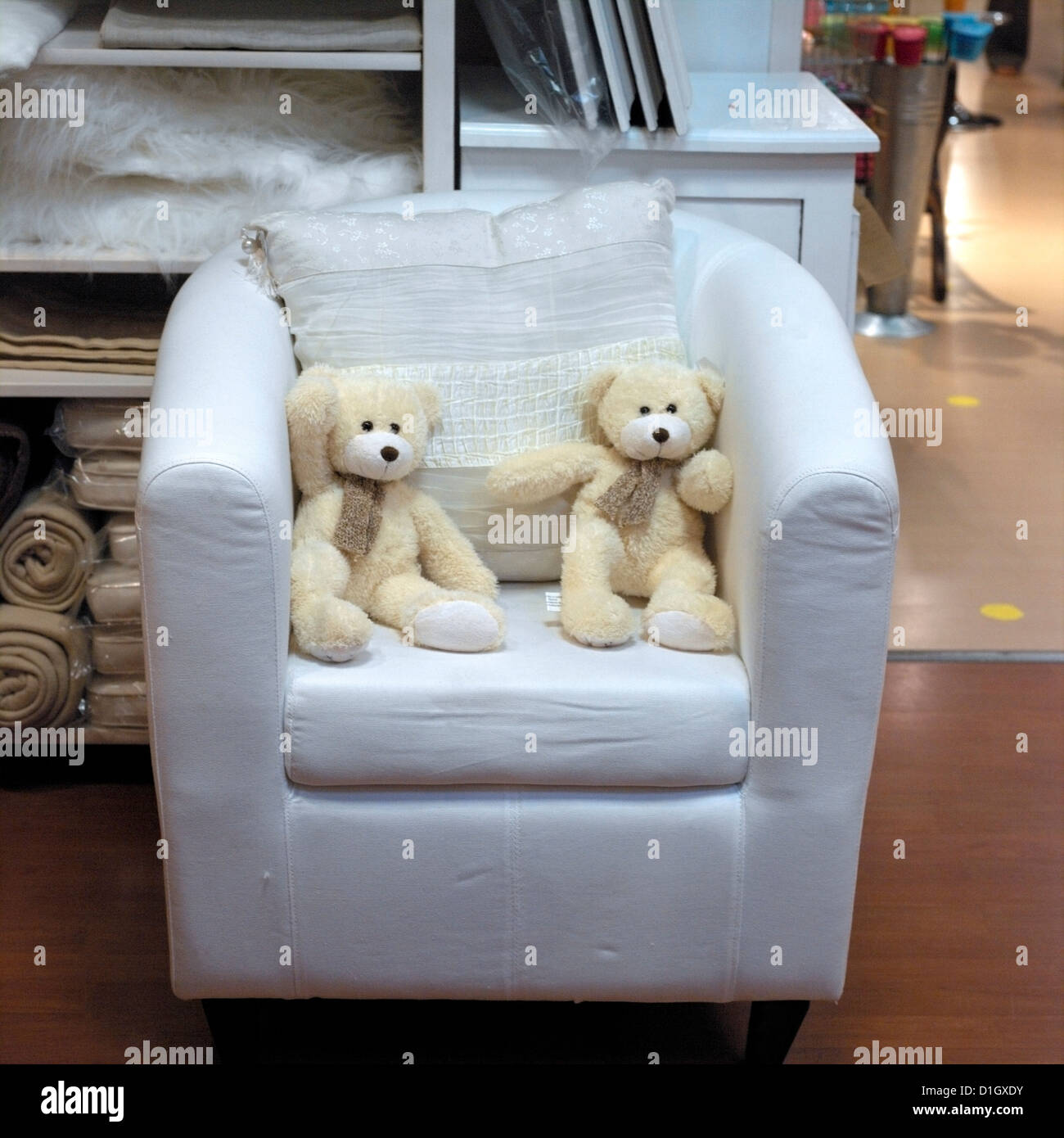 France Two White Teddy Bears in Armchair in Shop Stock Photo