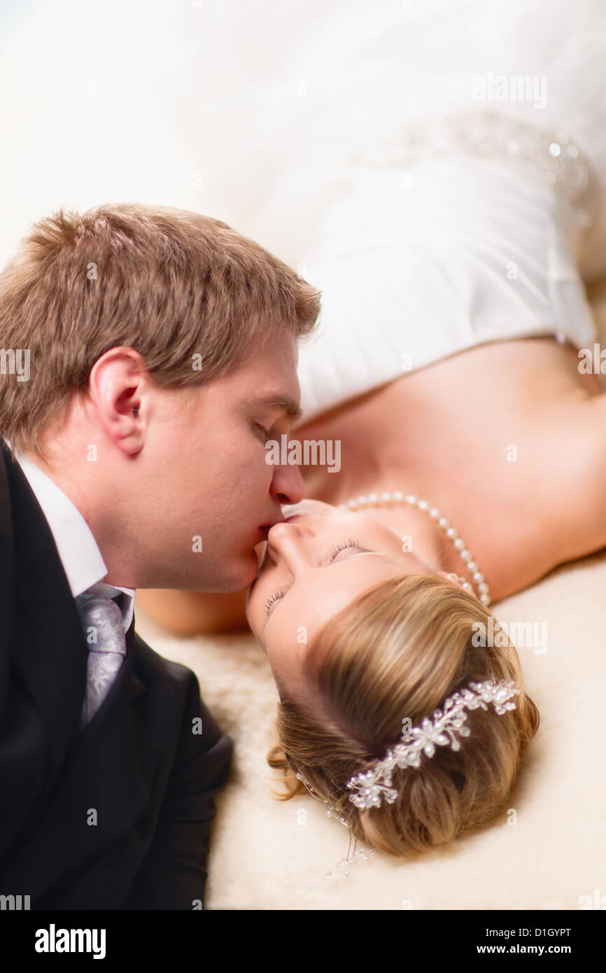Bride and groom have an intimate moment, very narrow depth of field and focus on bride eyes Stock Photo