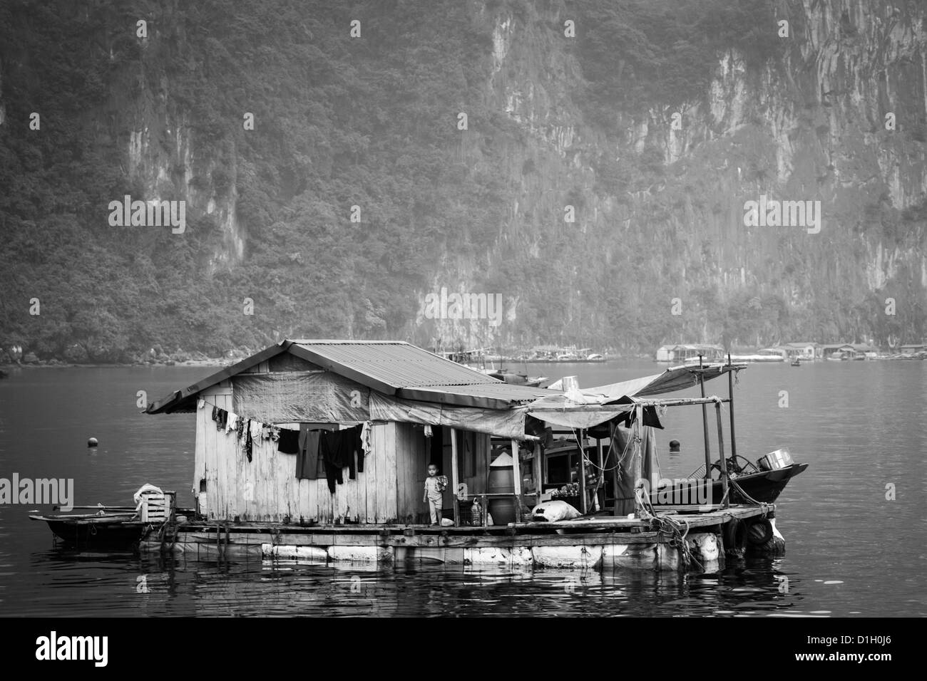 Black and white image of a floating house on Halong Bay near to Cat Ba Island in Vietnam Stock Photo