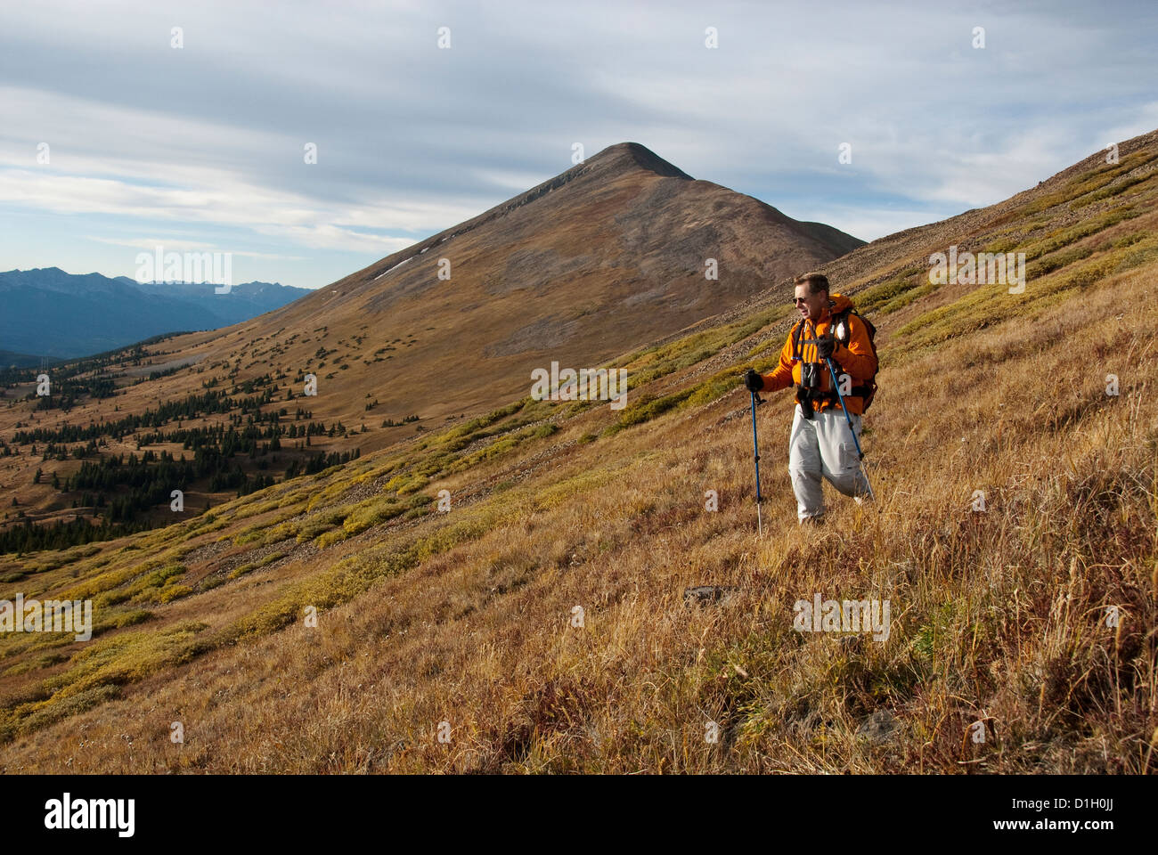 Mike Vining hiking down Boreas Mountain Bald Mountain in back Pike National Forest Colorado USA Stock Photo