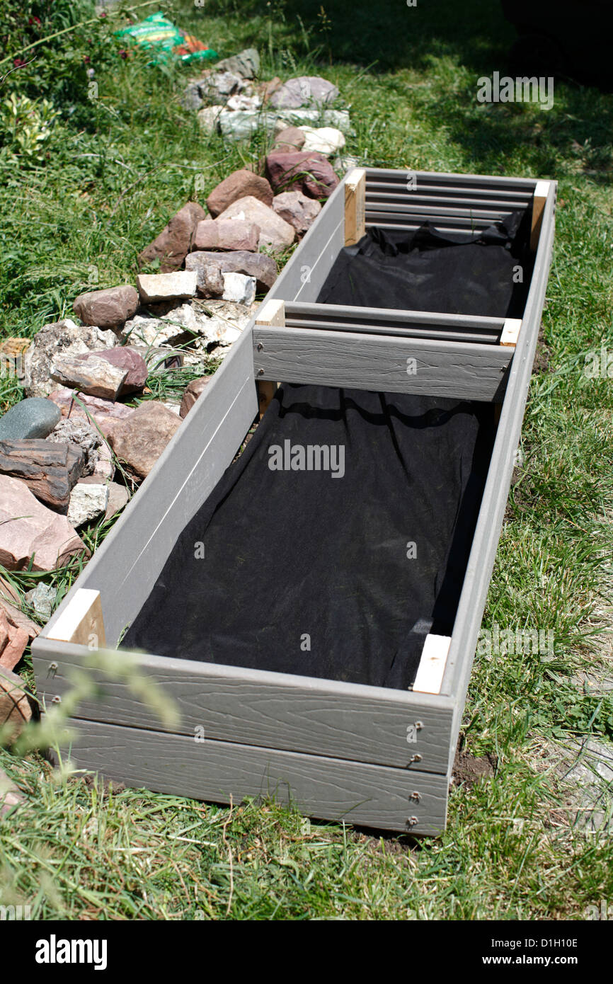 Homemade raised planting bed, showing black landscape cloth interior